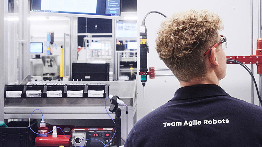 An Agile Robots employee inspecting the quality of a component at the production site in Kaufbeuren